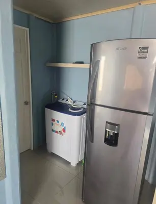 a kitchen with a refrigerator and a trash can at Apartamento DesCANsO #2 in Comunidad