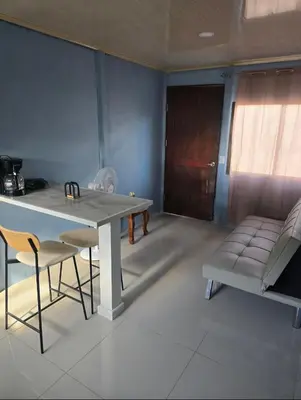 a dining room with a table and chairs and a couch at Apartamento DesCANsO #2 in Comunidad
