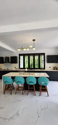 a kitchen with a table and chairs in a room at Residential Finca Celeste in Bijagua