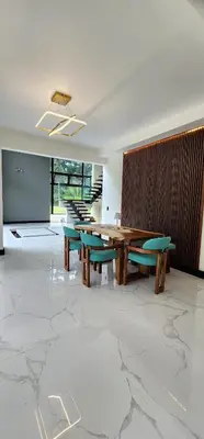 a dining room with a table and benches and a table and chairs at Residential Finca Celeste in Bijagua