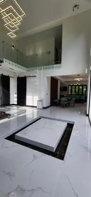 a large room with a white floor and a table at Residential Finca Celeste in Bijagua