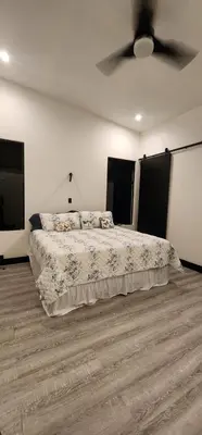 a bedroom with a bed with a ceiling fan at Residential Finca Celeste in Bijagua