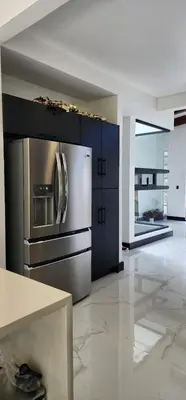 a kitchen with a stainless steel refrigerator and cabinets at Residential Finca Celeste in Bijagua
