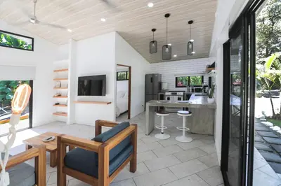 a kitchen and living room with a couch and a table at The Retreat Uvita in Uvita