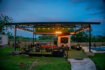a pavilion with lights and tables and chairs in a yard at Villa Vet Stylish 3BR Home - New Build - Perfect for families in Fortuna