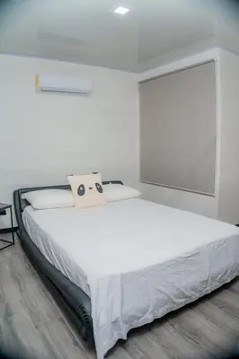 a white bedroom with a large white bed with a window at Villa Vet Stylish 3BR Home - New Build - Perfect for families in Fortuna