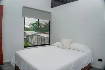 a bedroom with a white bed and a window at Villa Vet Stylish 3BR Home - New Build - Perfect for families in Fortuna