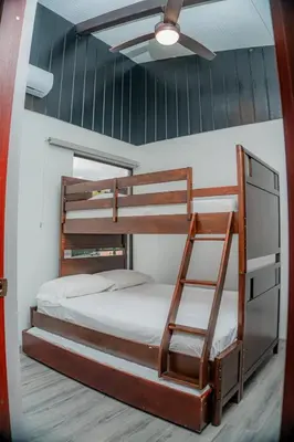 a bedroom with two bunk beds and a ceiling fan at Villa Vet Stylish 3BR Home - New Build - Perfect for families in Fortuna
