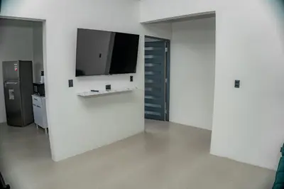 a white room with a tv on a wall at Villa Elemental Modern Villa Volcano Views & Luxe Touches in Fortuna