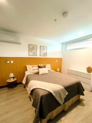 a bedroom with a large bed and a window at Luxury condo in Selva Coral Jacó Beach in Jacó