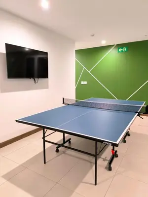 a ping pong table in a room with a tv at Luxury condo in Selva Coral Jacó Beach in Jacó