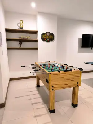 a foosball table in front of a wall with at Luxury condo in Selva Coral Jacó Beach in Jacó