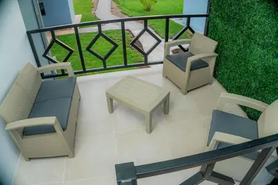 a balcony with two chairs and a table and a fence at Villa Sunset Relaxing 2BR Villa with Outdoor Hot Tub in Fortuna