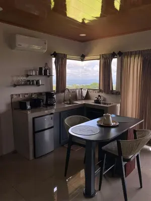 a kitchen with a table and a table and chairs at Villa Paraiso in Colonia