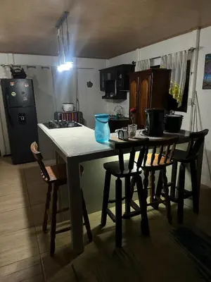 a kitchen with a table and chairs in a kitchen at Villa Elena Vacation Home in Nicoya