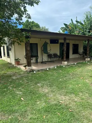 a house with a patio and a yard at Villa Elena Vacation Home in Nicoya