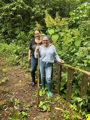 two women standing on a trail in the woods at Rio Paquita Lodge in Tapantí