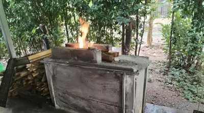 an outdoor stove with fire in a forest at Villa Elena Vacation Home in Nicoya
