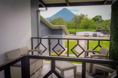 a balcony with chairs and a view of a mountain at Villa Sundrop Villa for 8 with Volcano Views & Family Comfort in Fortuna