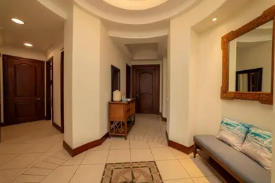 a living room with a couch and a mirror at Bella Vista 1C 3 bdrs garden view in Los Suenos in Herradura