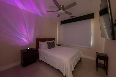 a bedroom with a bed and a ceiling fan at Miramar 3B 3 bdr Ocean View in Los Suenos in Herradura