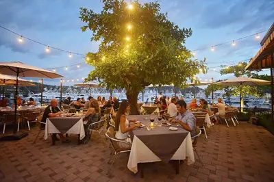 a group of people sitting at tables in a restaurant at Miramar 3B 3 bdr Ocean View in Los Suenos in Herradura