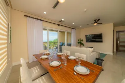 a dining room with a table and a couch at Miramar 3B 3 bdr Ocean View in Los Suenos in Herradura