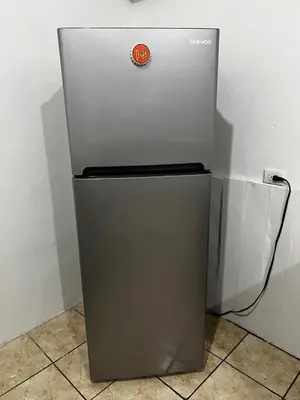 a silver refrigerator sitting in a corner next to a wall at Apartamento el Bosque in Nicoya