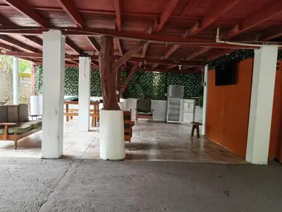 a pavilion with a table and chairs and a kitchen at Apartamento el Bosque in Nicoya