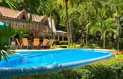 a swimming pool in front of a resort at Casa Descanso del Pescador in Garza