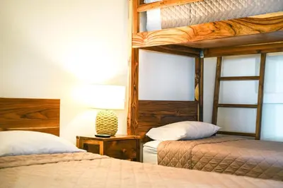 a bedroom with two bunk beds and a lamp at Casa Descanso del Pescador in Garza