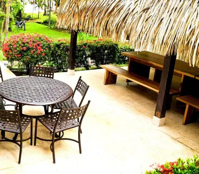 a table and chairs with a bench and a picnic table at Casa Descanso del Pescador in Garza