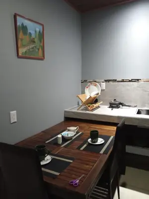 a wooden table with cups and plates on top of it at Yamis home in General Viejo