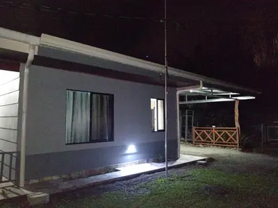 a house with a light on the side of it at night at Yamis home in General Viejo