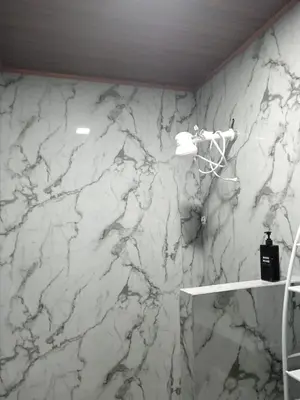 a white marble wall in a bathroom with a shelf at Yamis home in General Viejo