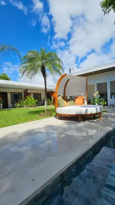a couch sitting in front of a house at Los Papyrus in Uvita