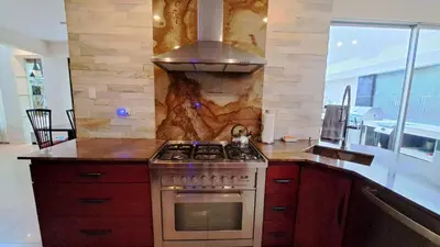 a kitchen with a stove and a counter top at La Miraje Villa in Quepos