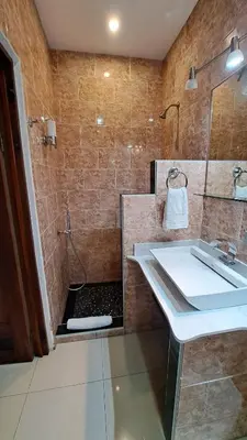 a bathroom with a sink and a shower at La Miraje Villa in Quepos