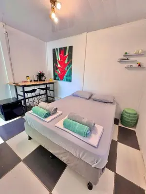a large bed in a room with a checkered floor at Perla Dreamy Cabin with Private Pool in Paraíso