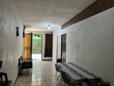 a room with a bed and a hallway with a door at Sleep&Go! Apartamento de 3 habitaciones in Siquirres
