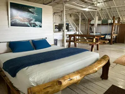 a bedroom with a bed made out of a log at Casa de Artistas in Playa Pelada