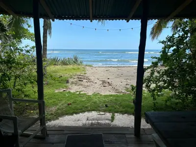 a view of the beach from the porch of a beach house at Casa de Artistas in Playa Pelada