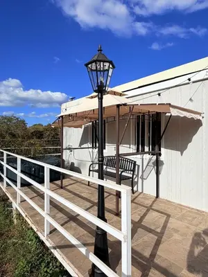 a street light on a deck with an umbrella at Cabinas Diana in San José Pinilla