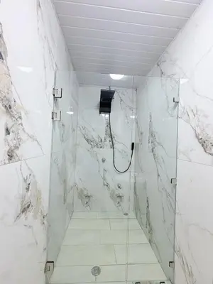 a bathroom with a shower with a glass door at Cabinas Diana in San José Pinilla