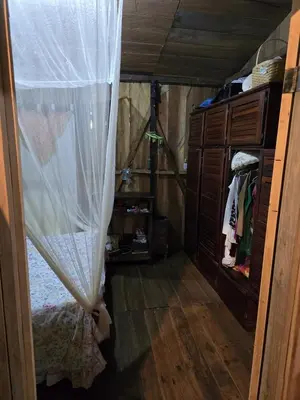 a small room with a bed and a curtain at Landscape-Cabaña winter full equipada in La Cruz