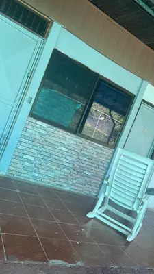 a window with a bench in front of a building at Casa Abbi in Cuajiniquil
