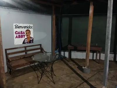 a room with a table and a sign on a wall at Casa Abbi in Cuajiniquil