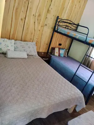 a bedroom with a bed and a bunk bed at Hospedaje oye in Rivas
