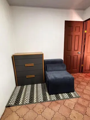 a room with a bed and a dresser and a door at Casa Girasol PZ in San Isidro
