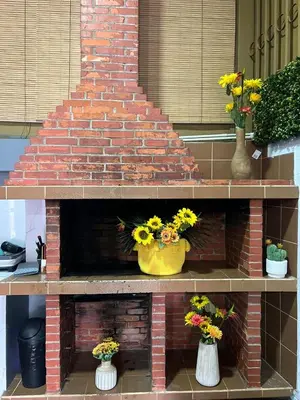 a brick fireplace with three vases of flowers on it at Casa Girasol PZ in San Isidro